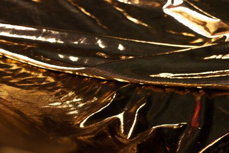 abstract background gold cloth or liquid gold. low keyの写真素材