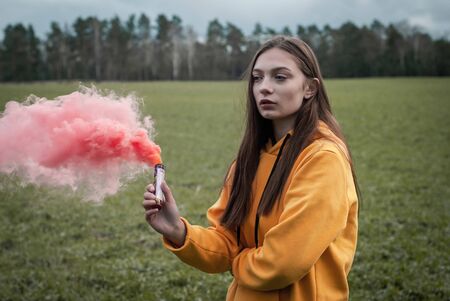 Young calm girl in pink smoke. sensual portrait,の写真素材