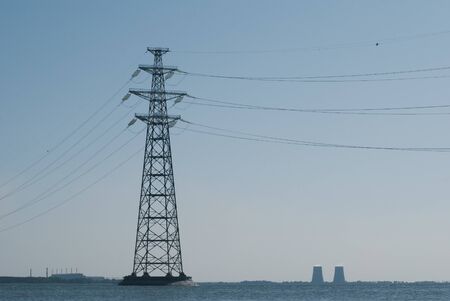 Electric pillar in the river. High voltage line,の写真素材