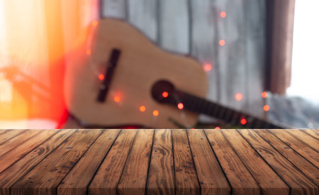 Empty wooden table with blurred musical background. banner for advertising guitar