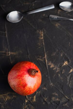 juicy pomegranate on dark concrete with bronze decor,の写真素材