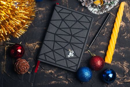 Black futuristic notebook at the Christmas table, the concept of creating a goalの写真素材