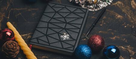 Black futuristic notebook at the Christmas table, the concept of creating a goalの写真素材
