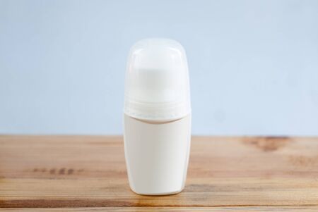 White bottle of deodorant. Advertising layout on a wooden tableの写真素材