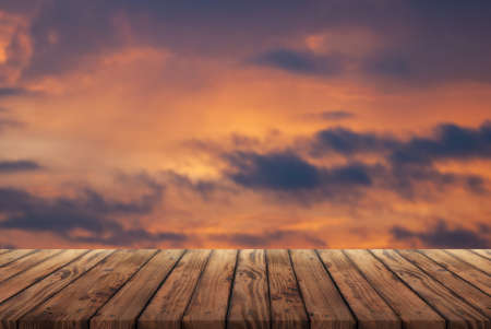 Wooden table for advertising products on the background of dramatic clouds,の写真素材