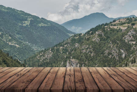 wooden table for advertising with the Alpine mountains in the backgroundの写真素材