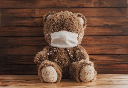 A Teddy bear in a medical mask. concept of infected covid-19 among childrenの写真素材