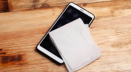 phone and napkin on a white wooden table, prevention of coronavirus,の写真素材