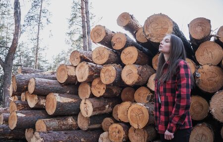 Hipster tender girl on the background of felled trees,の写真素材