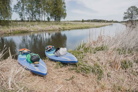 two sup boards on the beach with things, paddleboard travel conceptの写真素材