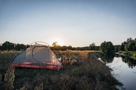 tent at sunset by the river, mosquito net,の写真素材