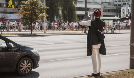 BELARUS, MINSK, AUGUST 16, 2020 an Indian man films a rally in Belarus on his phoneのeditorial素材