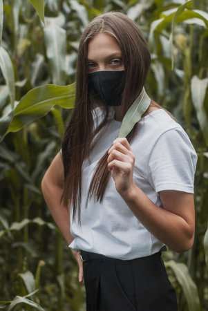 Young girl in a black medical mask,