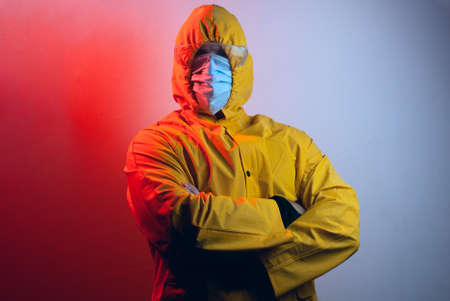 portrait of a virologist in a yellow suit and safety glasses,の写真素材