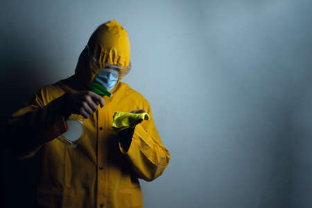 an employee in a protective suit disinfects the room,の写真素材
