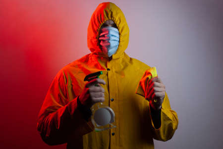 A man in a suit and medical mask disinfects the room,の写真素材