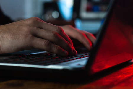 a man working in a laptop close-up, hands on the keyboard,の写真素材