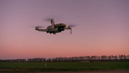 drone at sunset, quadrocopter against the skyの写真素材