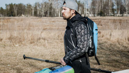 surfer with a paddle in a dry hydro suitの写真素材