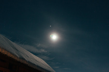 bright moon in the starry sky in winter, moon and jupiterの写真素材