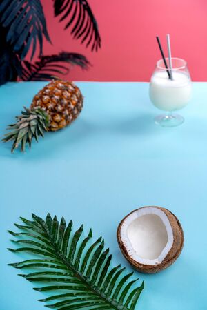 tropical background pink with coconut and pineapple top viewの写真素材