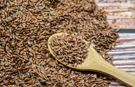 Flax seeds on a wooden spoonの写真素材