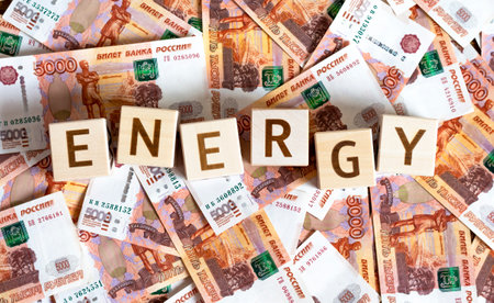 Wooden cubes with the inscription: "Energy" and money with a face value of 5000 rubles. The concept of earning, planning, investing, business, income, energy saving, payment for electricity.の写真素材
