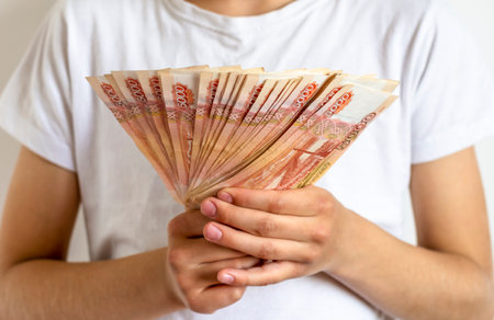 Russian banknotes of 5000 rubles in the hands of a man. The concept of finance, investment, savings and cash.の写真素材