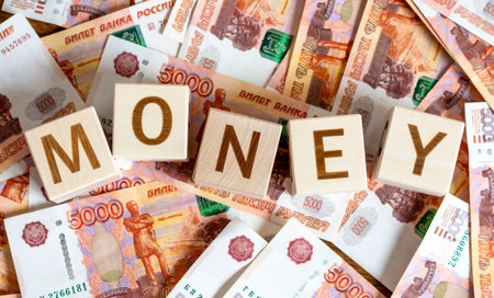 Wooden cubes with the inscription: Money and money with a face value of 5000 rubles. The concept of...