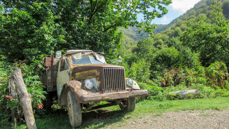Old soviet-russian car in the rural Caucasian villageの写真素材