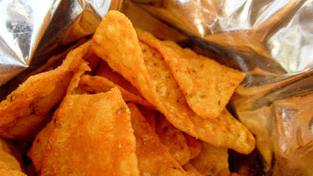 Close up, top view of a potato chips in a opened package