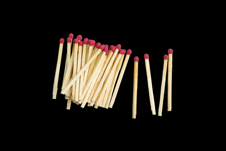 Many red head matches on black background.の写真素材