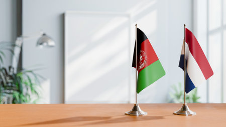 FLAGS OF AFGHANISTAN AND NETHERLANDS ON TABLEの写真素材