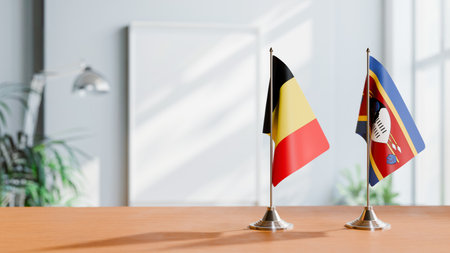 FLAGS OF  BELGIUM AND ESWATINI  ON TABLEの写真素材