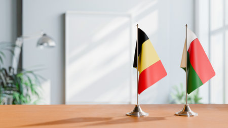 FLAGS OF  BELGIUM AND MADAGASCAR  ON TABLEの写真素材