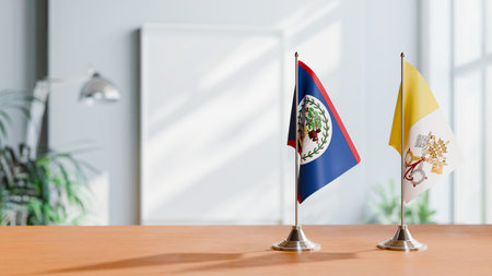 FLAGS OF BELIZE AND VATICAN ON TABLEの写真素材