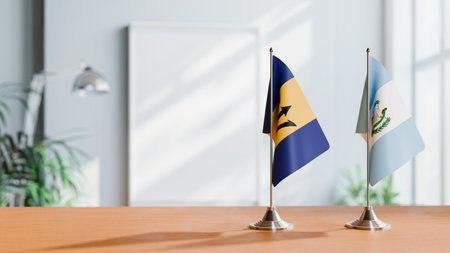 FLAGS OF BARBADOS AND GUATEMALA ON TABLEの写真素材