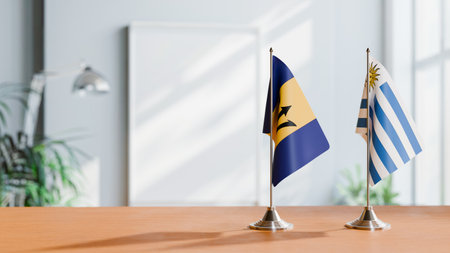 FLAGS OF  BARBADOS AND URUGUAY  ON TABLEの写真素材