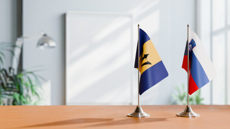 FLAGS OF  BARBADOS AND SLOVENIA  ON TABLEの写真素材