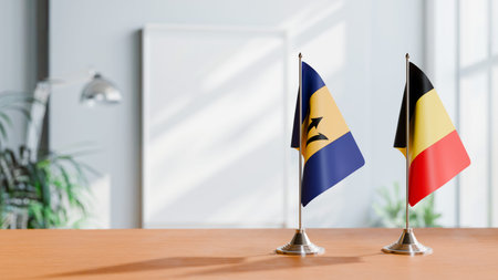 FLAGS OF  BARBADOS AND BELGIUM  ON TABLE