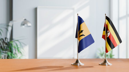 FLAGS OF  BARBADOS AND UGANDA  ON TABLEの写真素材
