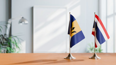 FLAGS OF  BARBADOS AND THAILAND  ON TABLEの写真素材