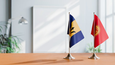 FLAGS OF  BARBADOS AND KYRGYZSTAN  ON TABLEの写真素材