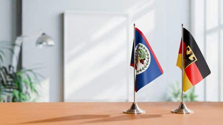 FLAGS OF BELIZE AND GERMANY ON TABLEの写真素材