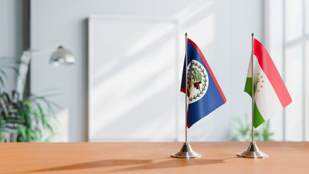 FLAGS OF BELIZE AND TAJIKISTAN ON TABLEの写真素材