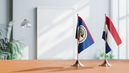 FLAGS OF BELIZE AND NETHERLANDS ON TABLEの写真素材