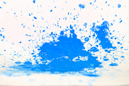 Blue paint spatter on a white background.