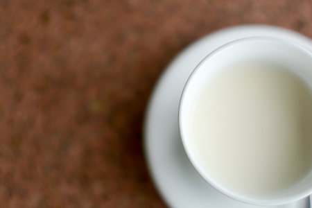 Hot milk and white cup on tableの写真素材
