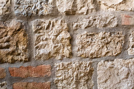 Stone wall texture with two new red bricksの写真素材