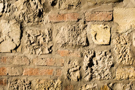The art texture of a old stonewall and new red bricksの写真素材